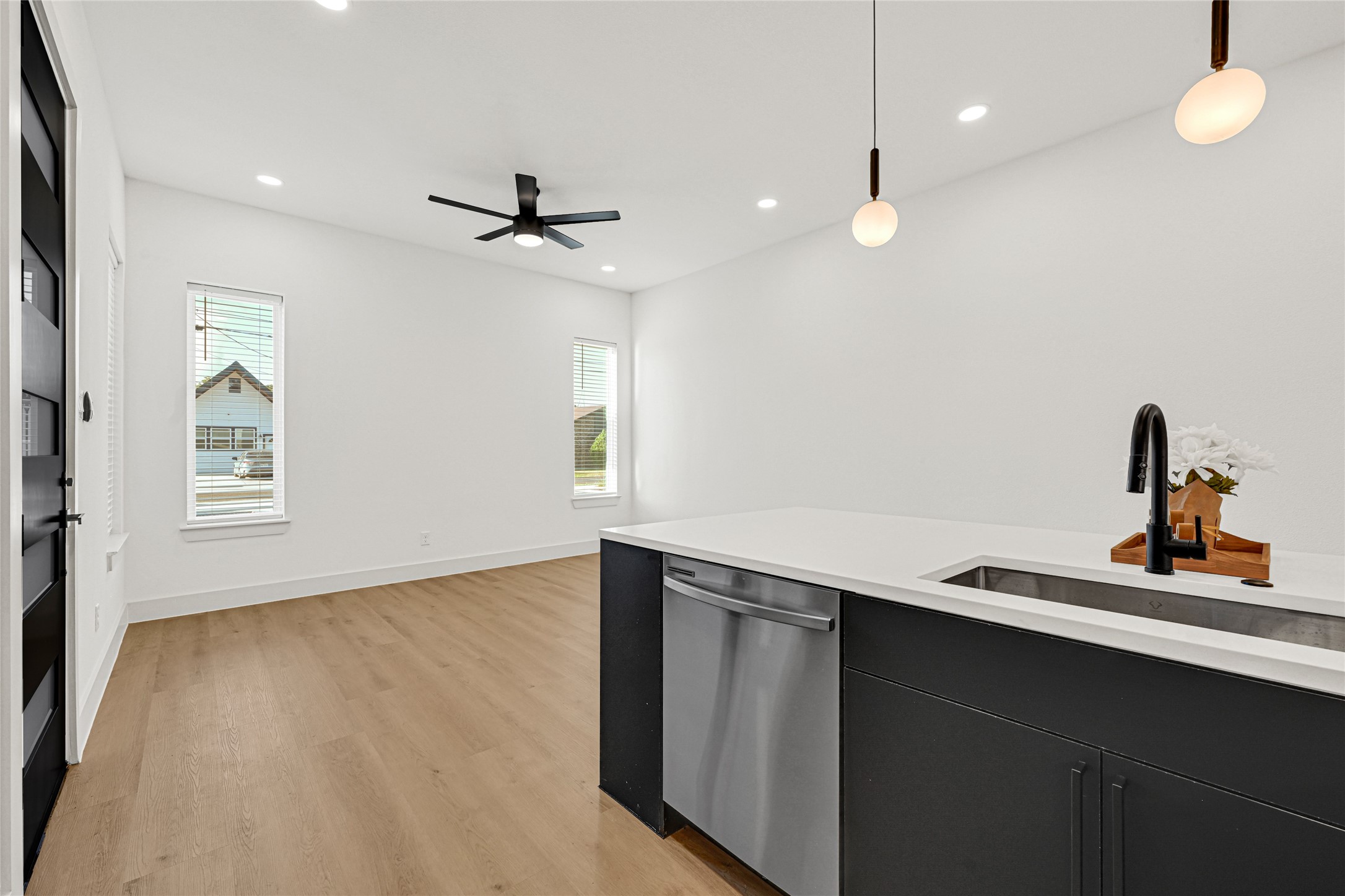 327 Tite Street, Unit B Houston, TX 77029 - Photo 13 of 22 a kitchen with a sink a window and wooden floor