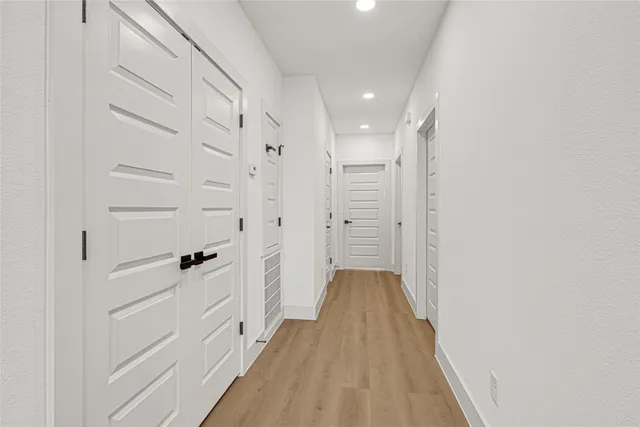 an empty room with a window and a ceiling fan