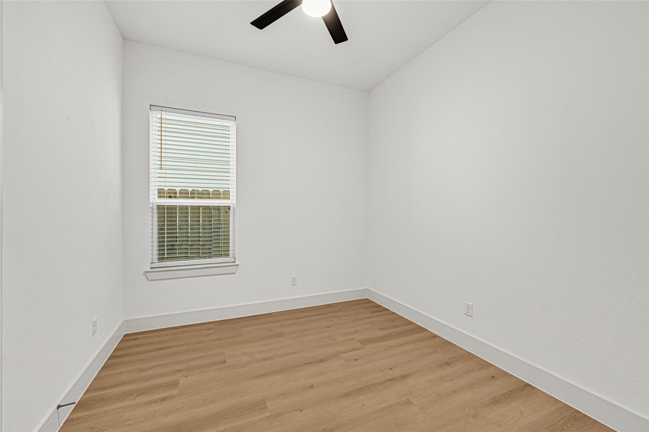 327 Tite Street, Unit B Houston, TX 77029 - Photo 16 of 22 an empty room with a window and a ceiling fan
