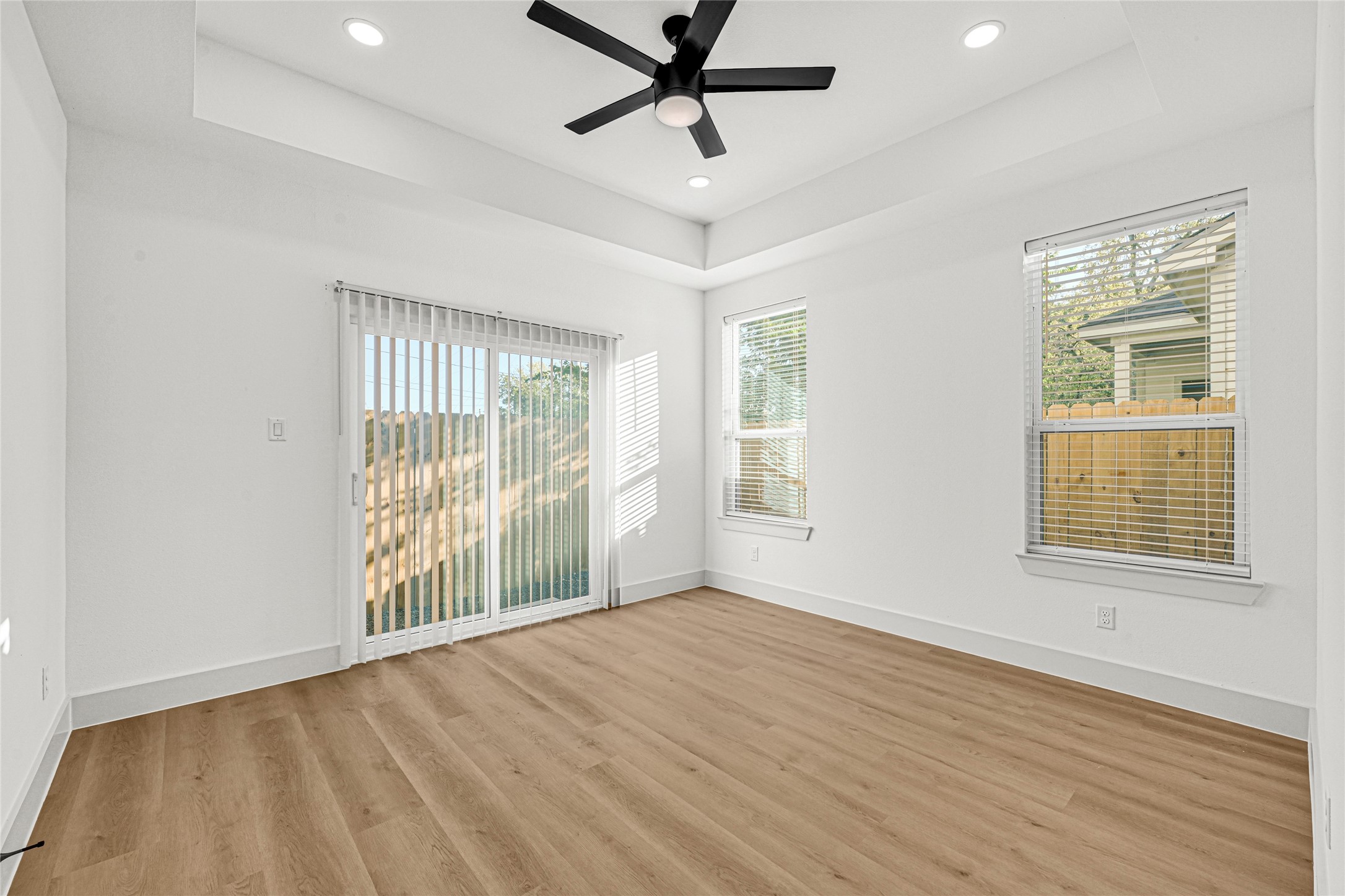 327 Tite Street, Unit B Houston, TX 77029 - Photo 19 of 22 a view of an empty room with a window and wooden floor