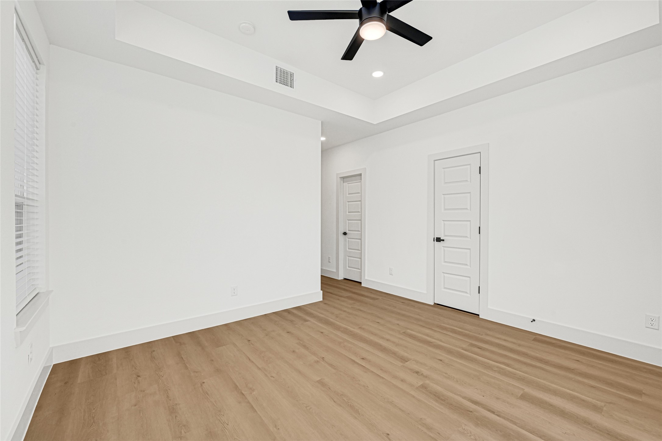 327 Tite Street, Unit B Houston, TX 77029 - Photo 20 of 22 an empty room with a ceiling fan and wooden floor