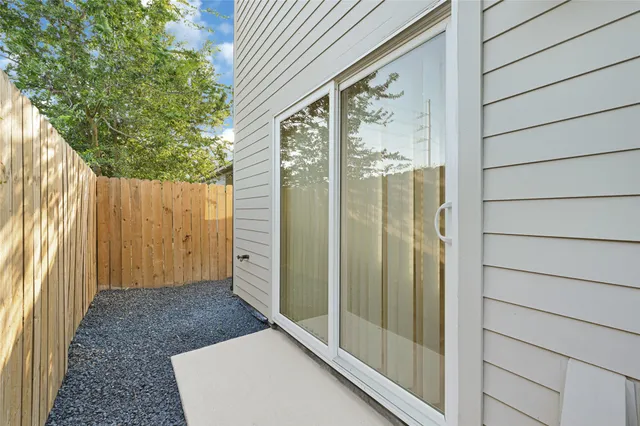 a large kitchen with a refrigerator and window