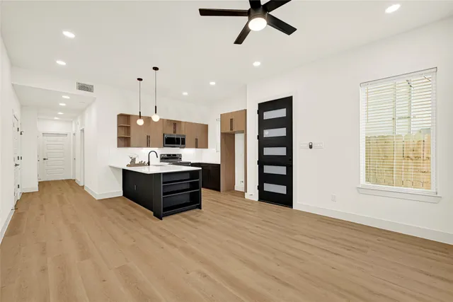 a view of a livingroom with a ceiling fan and window