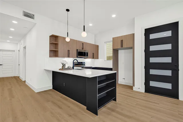 a kitchen with sink a stove and refrigerator