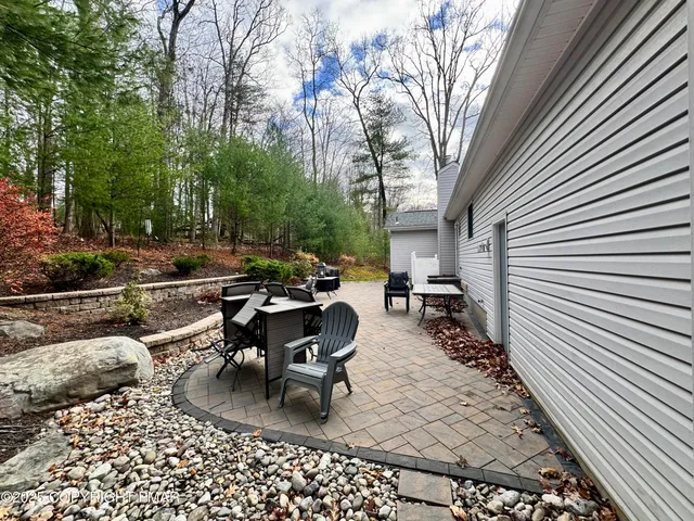 a backyard of a house with table and chairs