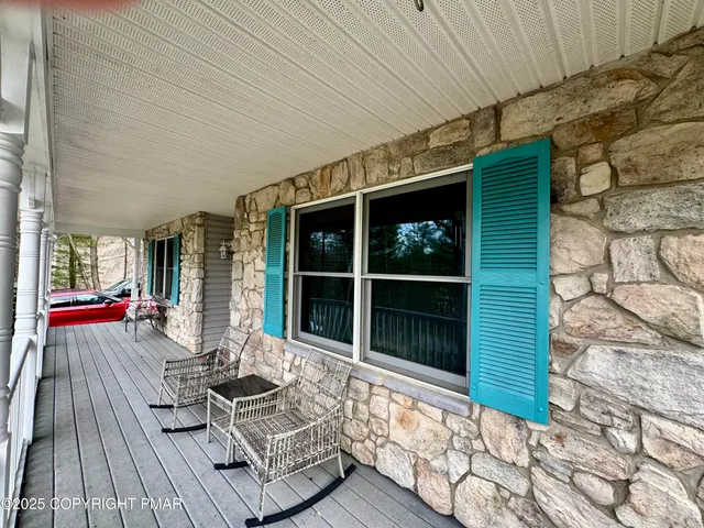 a view of a deck with wooden floor and iron fence