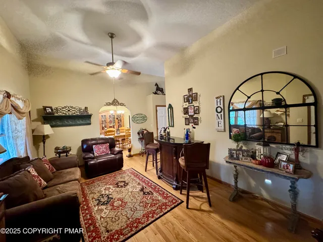 a living room with furniture a rug and a chandelier