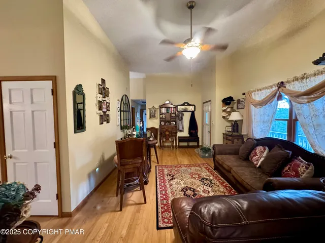 a living room with furniture a chandelier and a flat screen tv