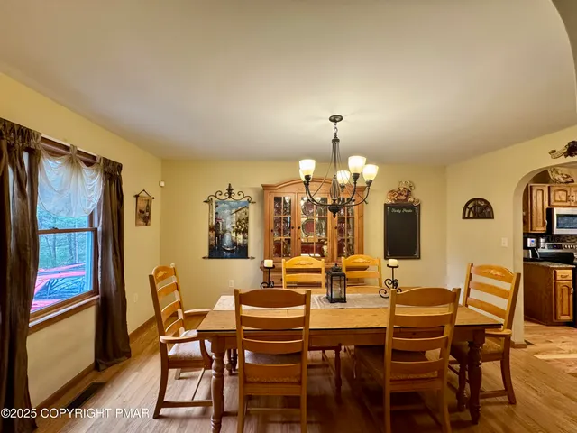a view of a dining room with furniture and chandelier