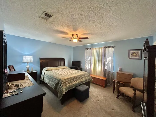 a bedroom with a bed couch and window