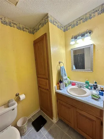 a bathroom with a sink mirror vanity and toilet