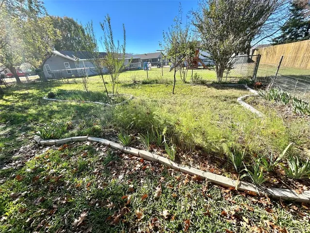 a backyard of a house with lots of green space