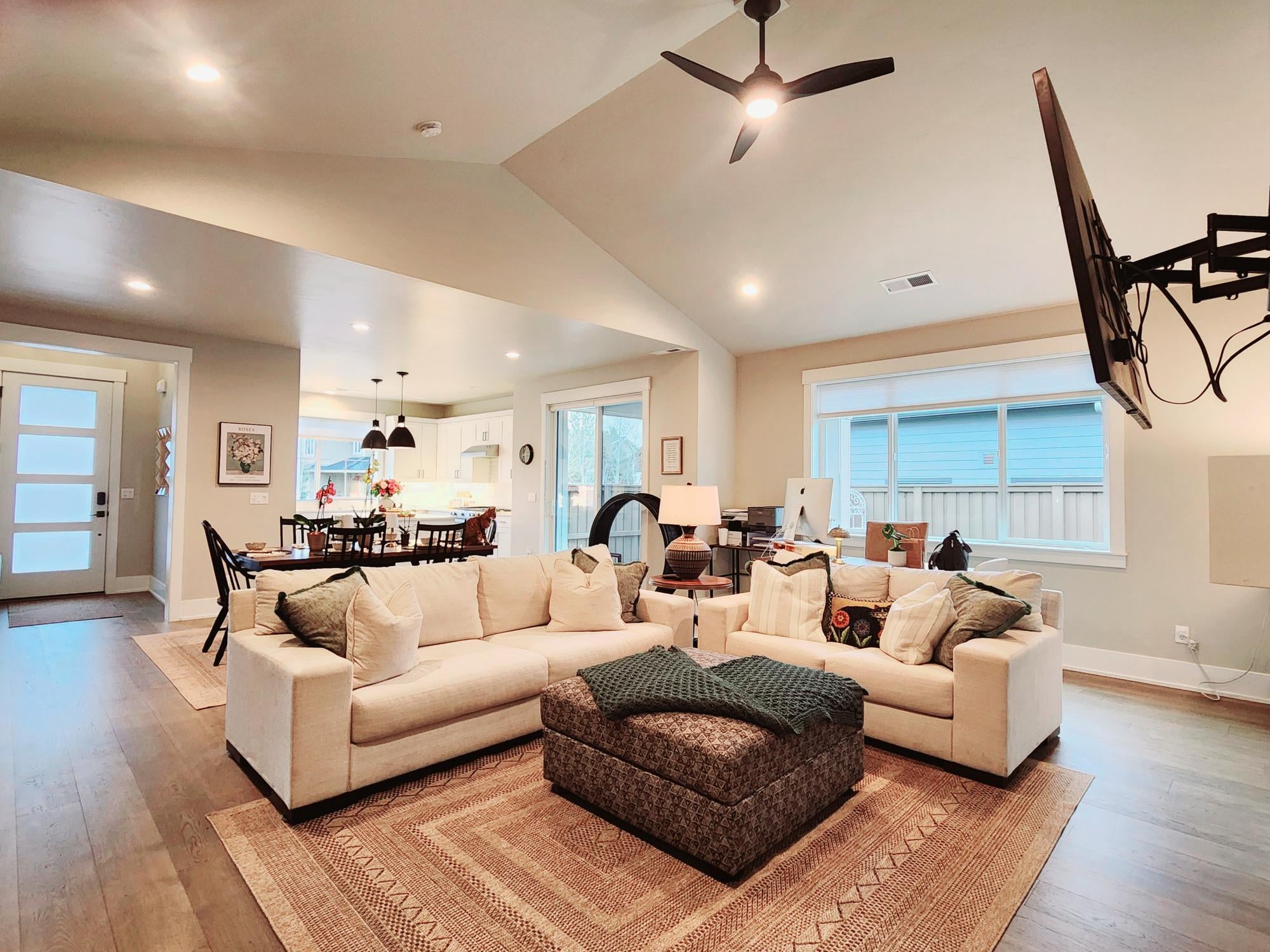 Great room is light and bright, has a ceiling fan.