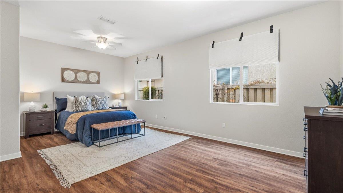 1181 Segolily Lane Lincoln, CA 95648 - Photo 20 of 31 a spacious bedroom with a bed a chandelier and closet