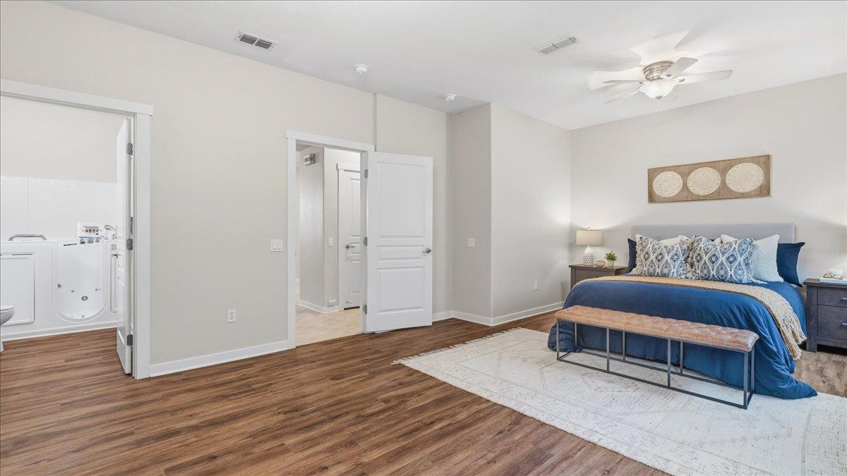 1181 Segolily Lane Lincoln, CA 95648 - Photo 21 of 31 a spacious bedroom with a bed and a ceiling fan