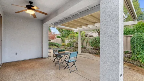 a front view of a house with lots of flowers