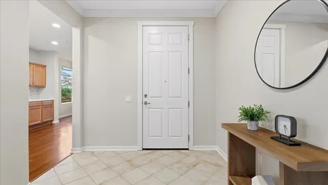 a large kitchen with stainless steel appliances granite countertop a lot of counter space and wooden floors