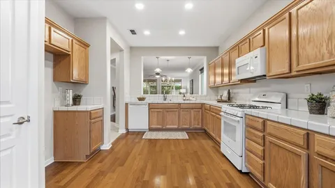 a view of kitchen with furniture and wooden floor