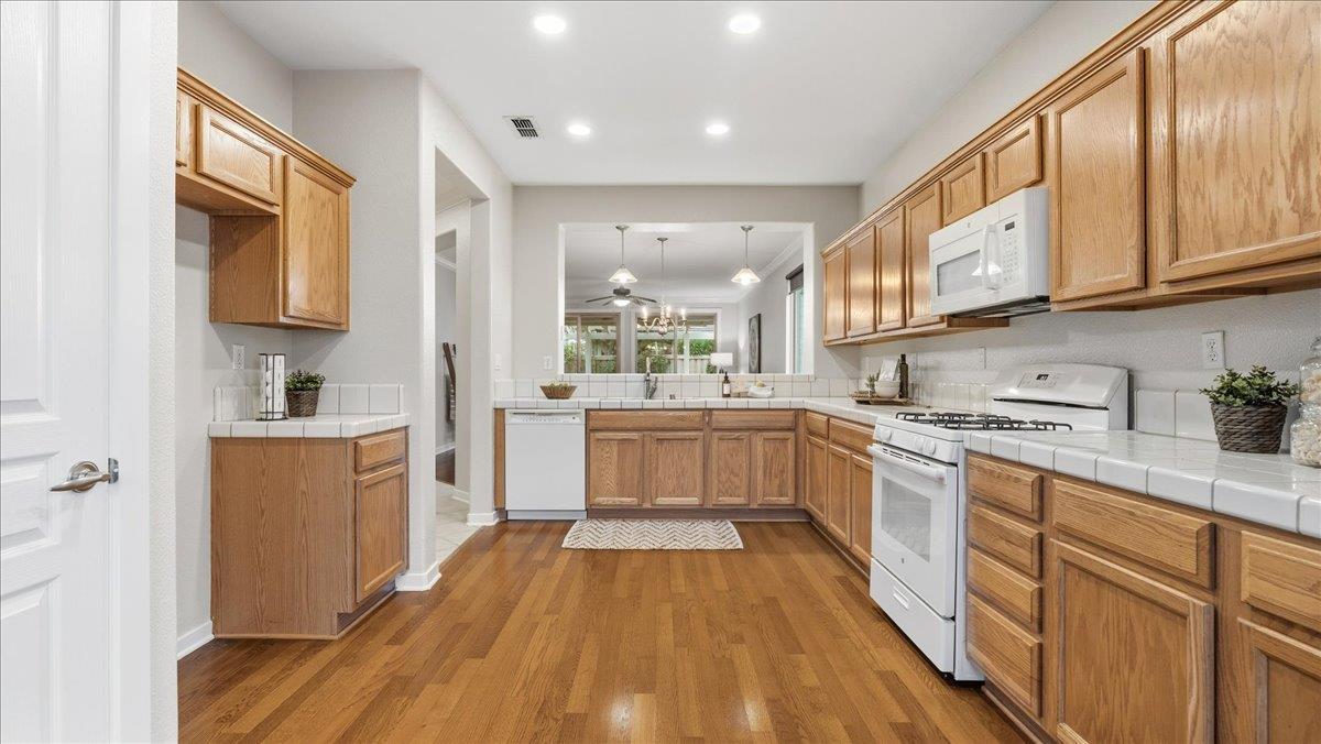 1181 Segolily Lane Lincoln, CA 95648 - Photo 6 of 31 a large kitchen with stainless steel appliances granite countertop a lot of counter space and wooden floors