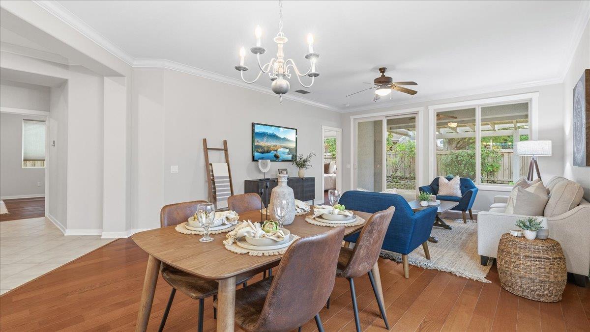 1181 Segolily Lane Lincoln, CA 95648 - Photo 9 of 31 a view of a dining room with furniture a chandelier and wooden floor