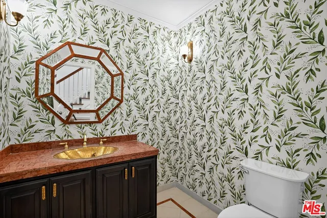 an empty room with wooden floor closet and windows