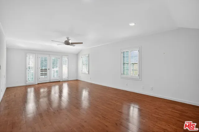 a view of backyard with wooden floor and fence