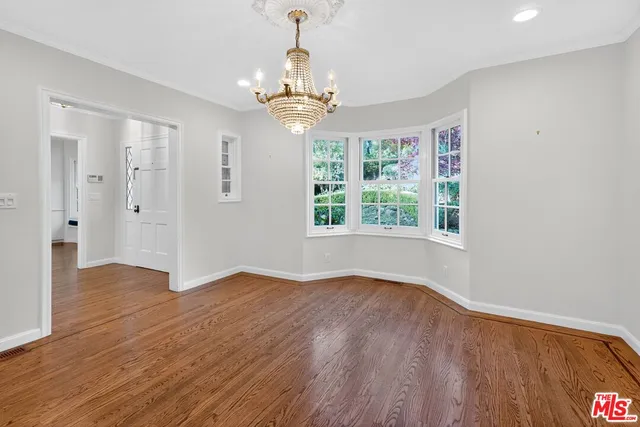 a kitchen that has a stove a table and chairs in it