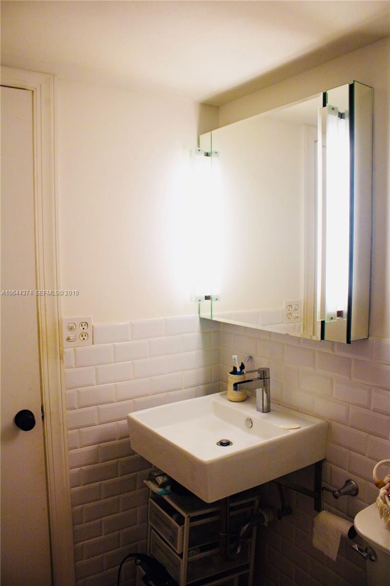 6368 Jack Rabbit Lane, Unit 6368 Hialeah, FL 33014 - Photo 9 of 12 a bathroom with a sink and a mirror