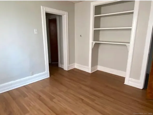 a view of a room with wooden floor
