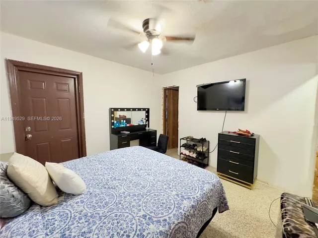 a view of a room with furniture and a window