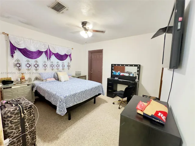 a large bed sitting in a bedroom next to a window