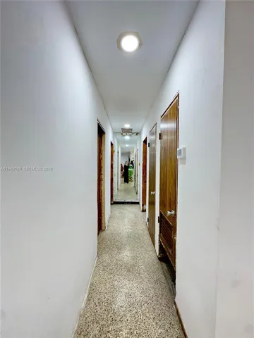 a bedroom with a bed and a flat tv screen on the dresser