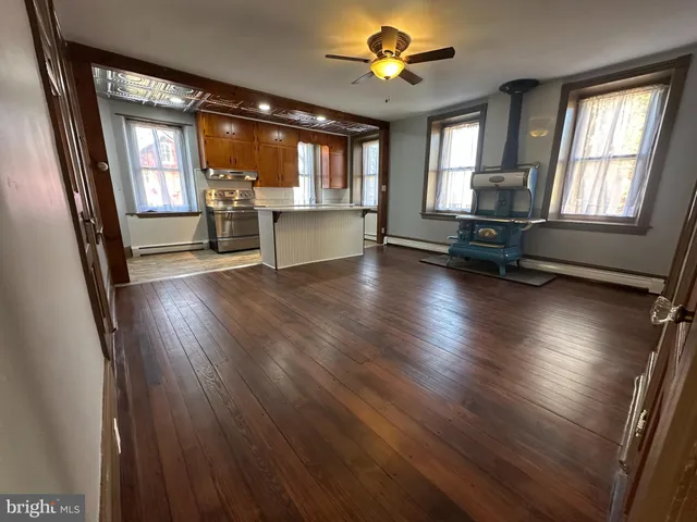 a kitchen with granite countertop a stove and a refrigerator