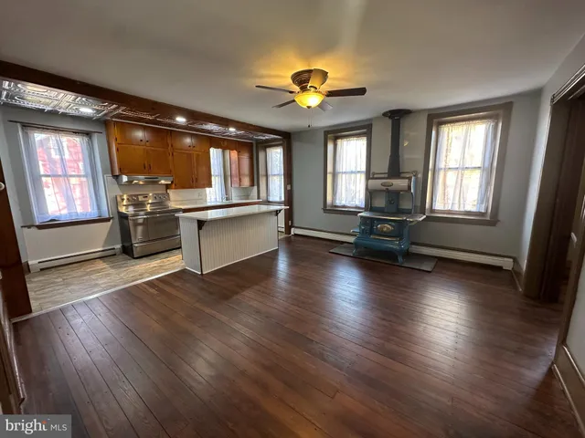 a living room with a table and windows