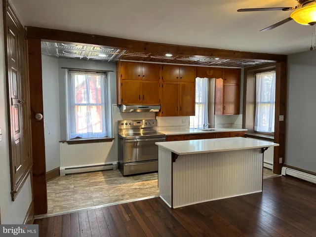 a living room with fireplace furniture and a window