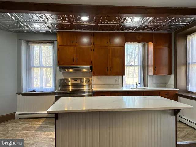 a view of a hallway with wooden floor and stairs