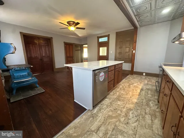 a view of a hallway with wooden floor and entryway
