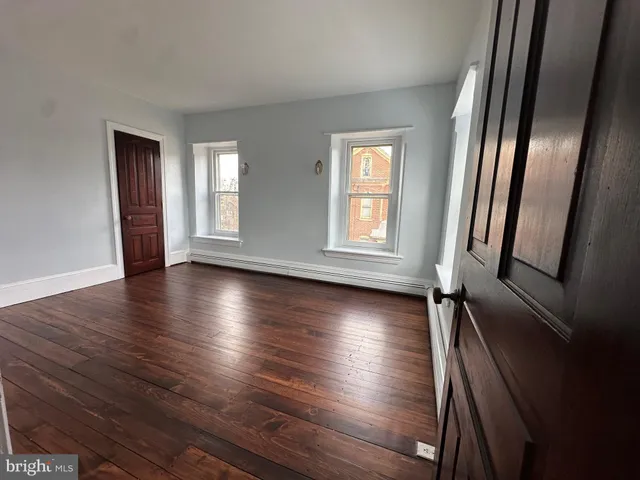 a view of a field with trees in the background
