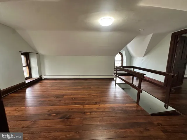 a view of a room with wooden stairs