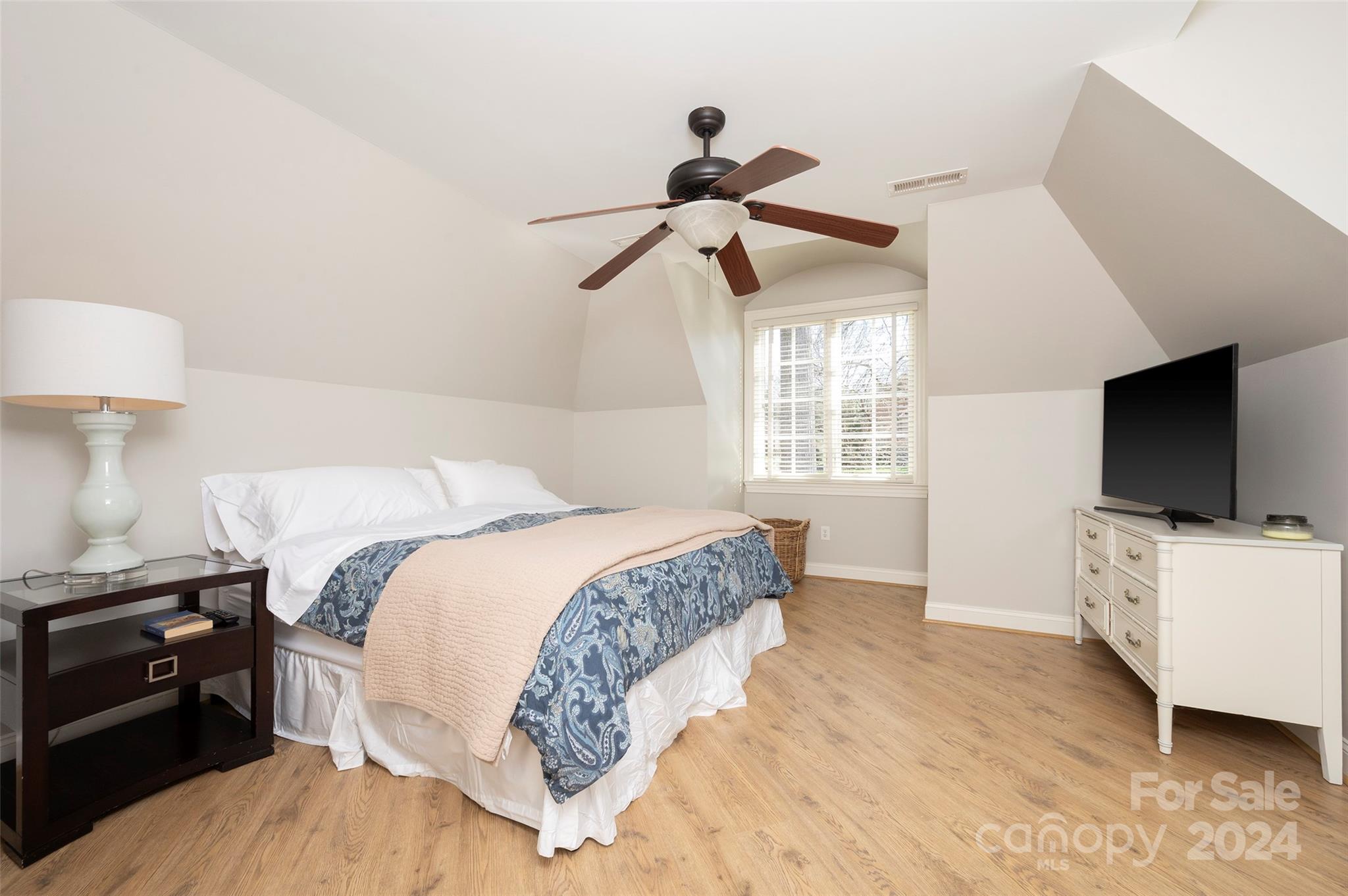 287 James Way Advance, NC 27006 - Photo 28 of 45 a bedroom with a bed and a flat tv screen on a dresser