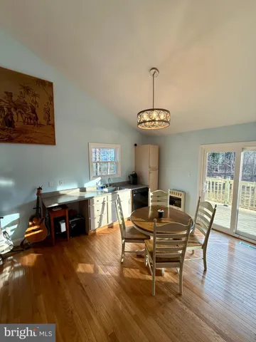 a bathroom with a sink a toilet a mirror and shower curtain