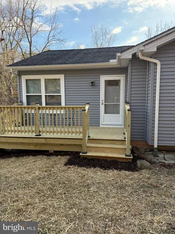 a view of a house with a wooden deck