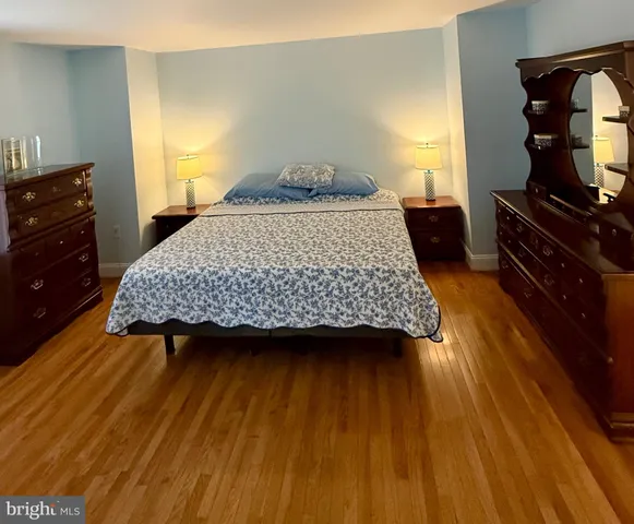 a bedroom with a bed and dresser