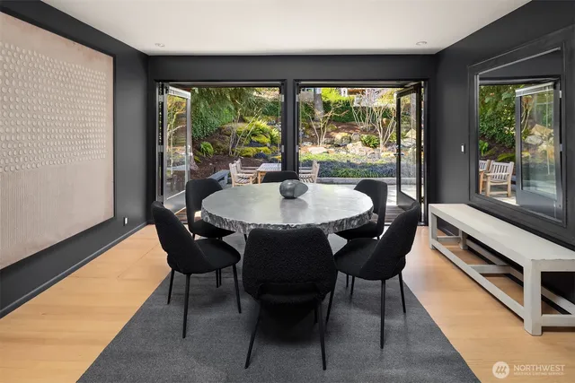 a dining room with furniture a chandelier and wooden floor