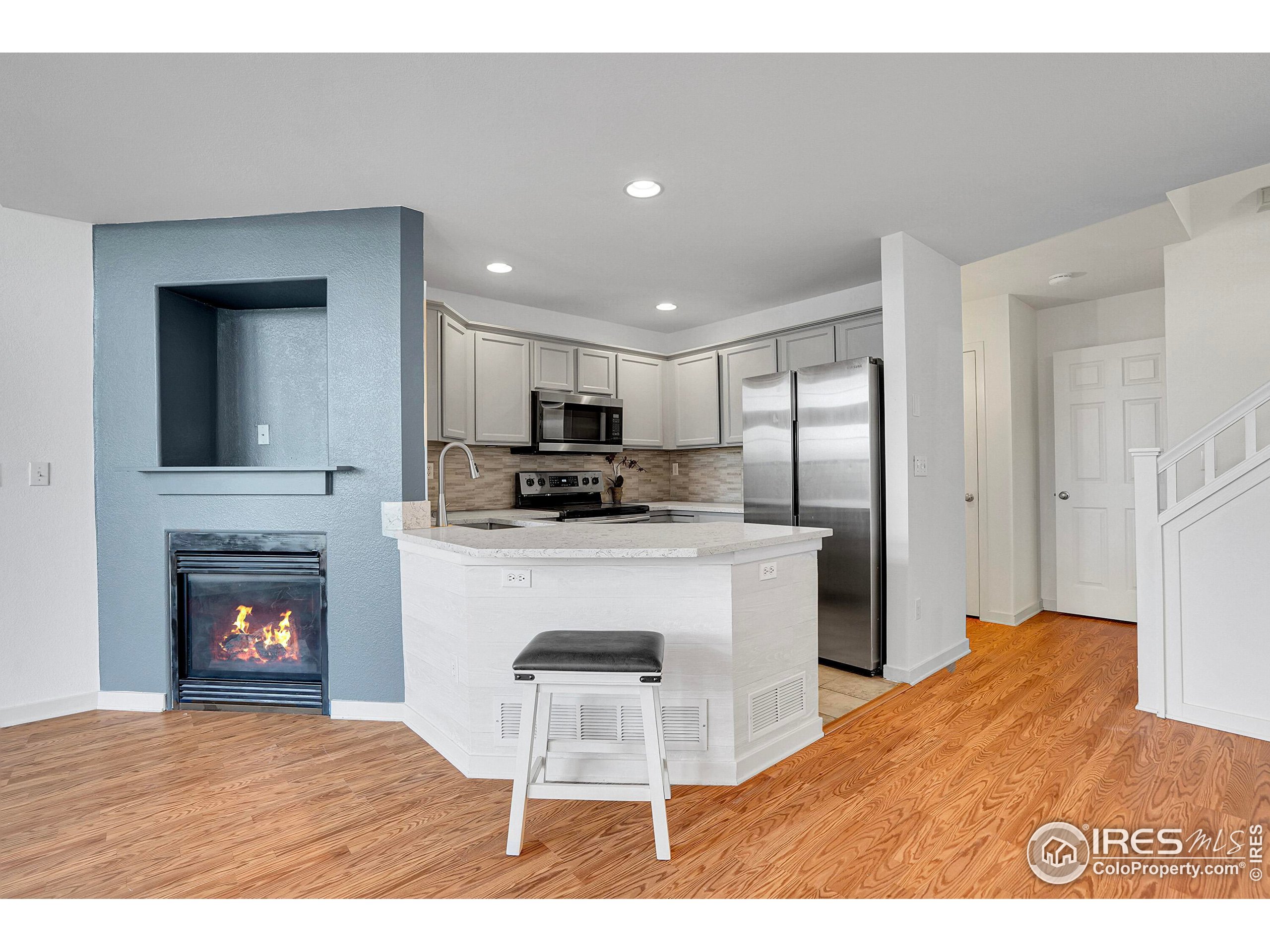 2408 Concord Circle Lafayette, CO 80026 - Photo 13 of 49 a kitchen view with stainless steel appliances kitchen island granite countertop a refrigerator stove top oven and sink