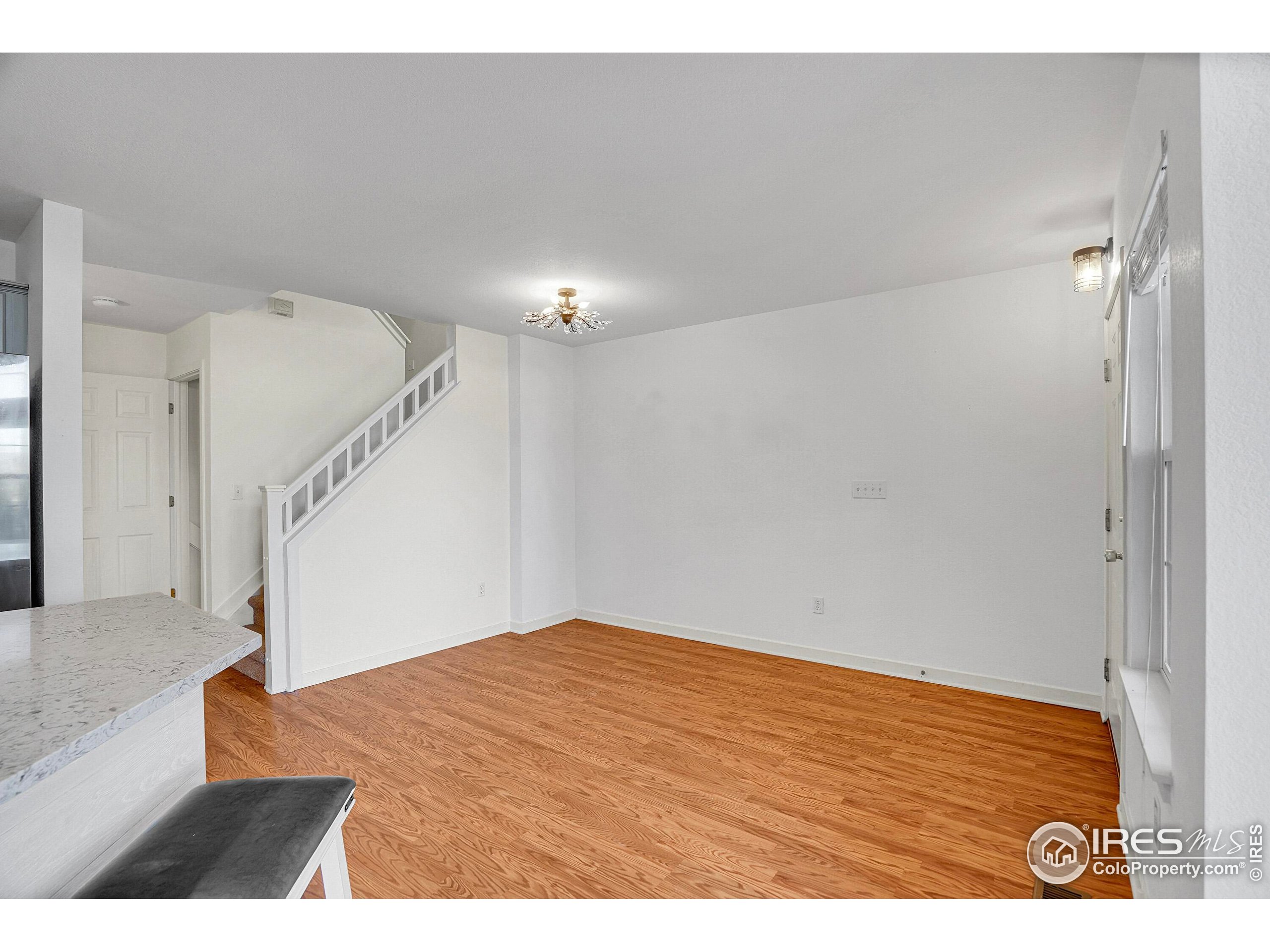 2408 Concord Circle Lafayette, CO 80026 - Photo 15 of 49 a view of an empty room with stairs and wooden floor