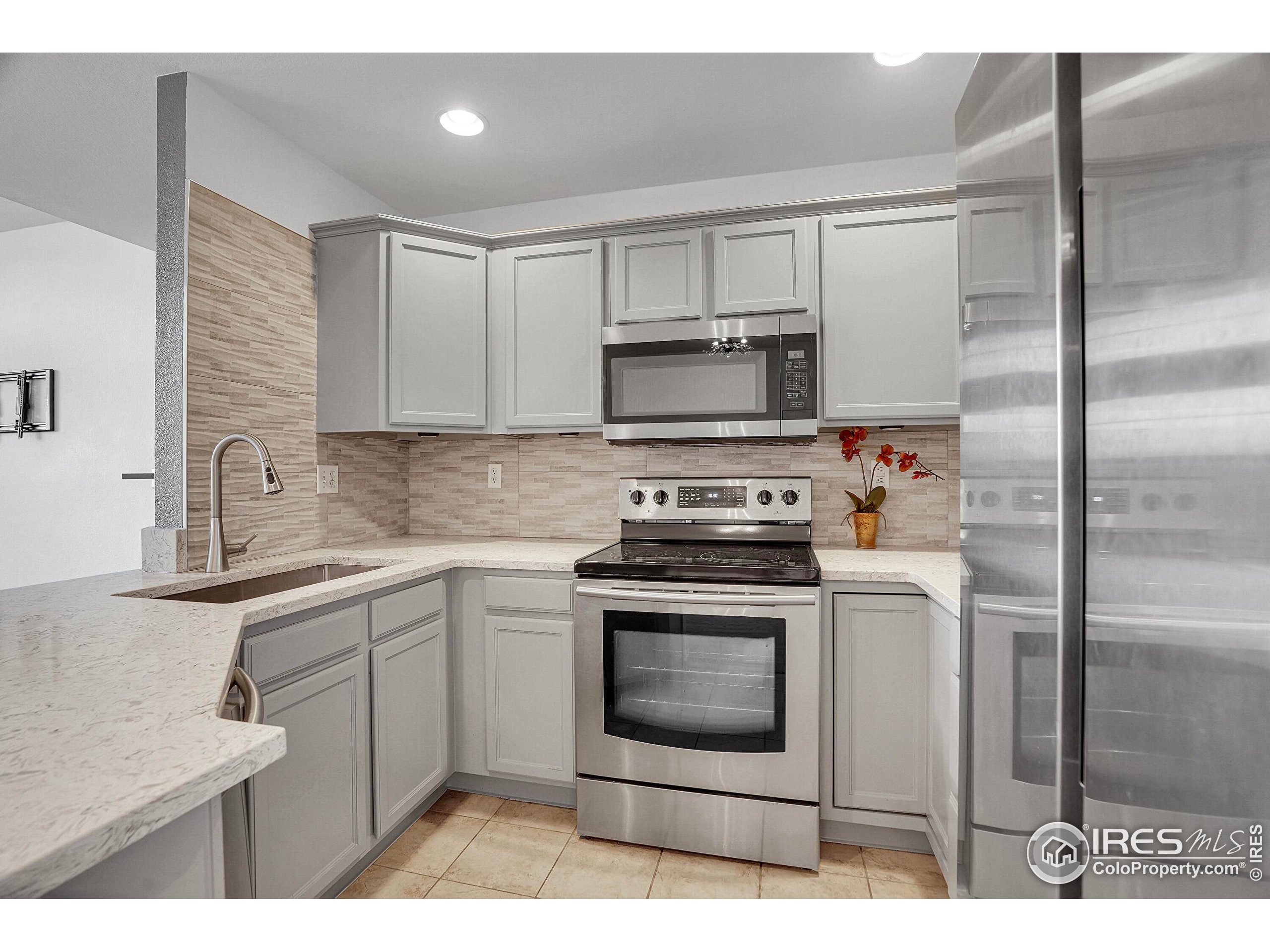 2408 Concord Circle Lafayette, CO 80026 - Photo 16 of 49 a kitchen with a stove microwave and refrigerator
