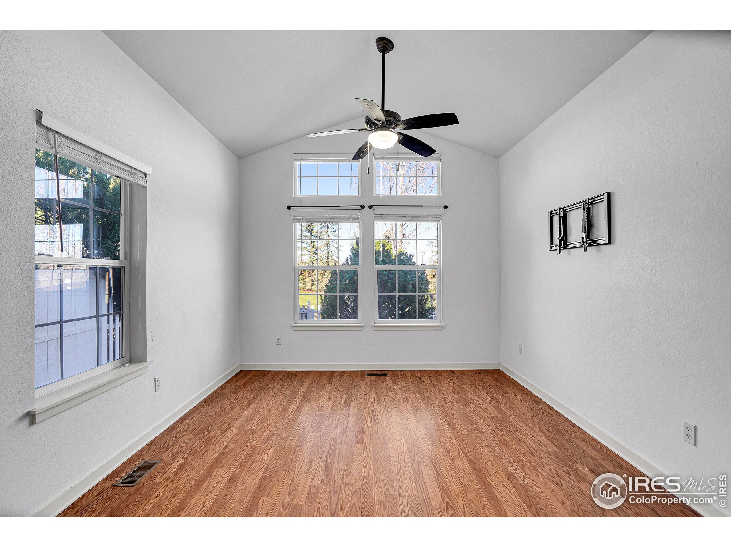 2408 Concord Circle Lafayette, CO 80026 - Photo 19 of 49 a view of an empty room with wooden floor and a window