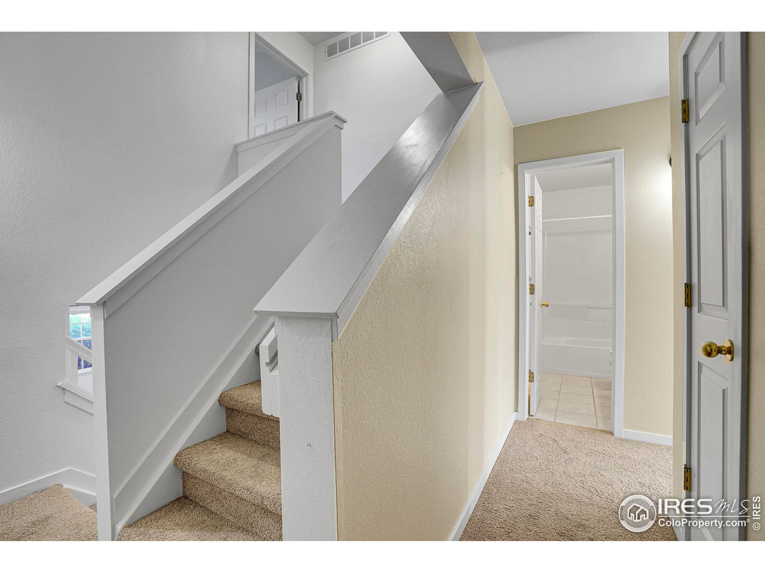 2408 Concord Circle Lafayette, CO 80026 - Photo 25 of 49 a view of a hallway with white walls and stairs