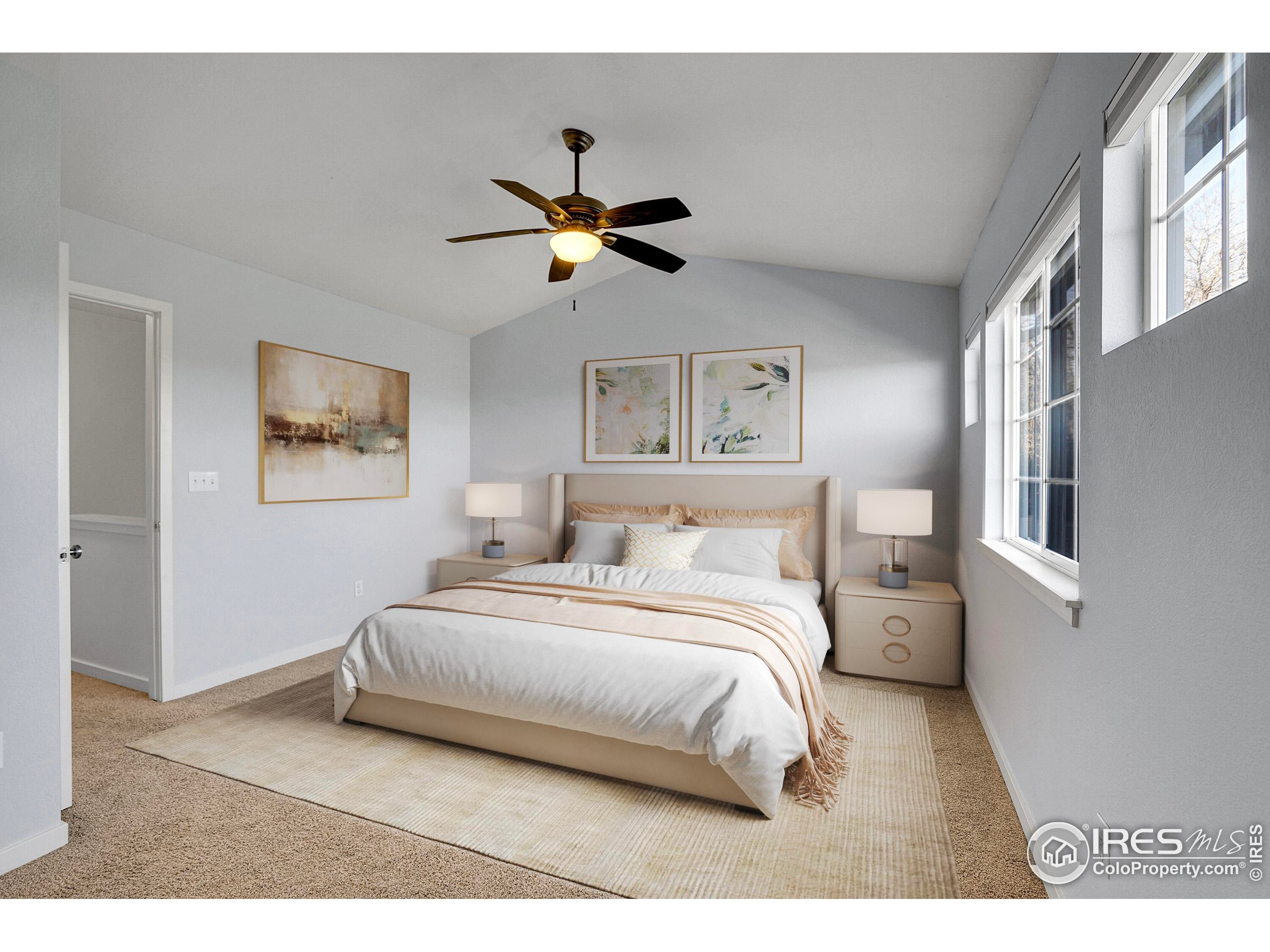 2408 Concord Circle Lafayette, CO 80026 - Photo 26 of 49 a bedroom with a bed painting on the wall and a window